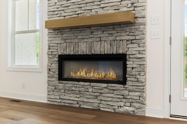 1065 Gholson Rd, Clarksville, TN 37043 - room details with baseboards, visible vents, a stone fireplace, and wood finished floors