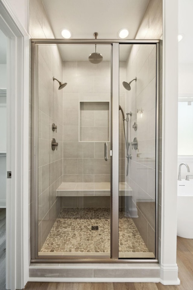 1065 Gholson Rd, Clarksville, TN 37043 - full bathroom with a soaking tub, a shower stall, and wood finished floors