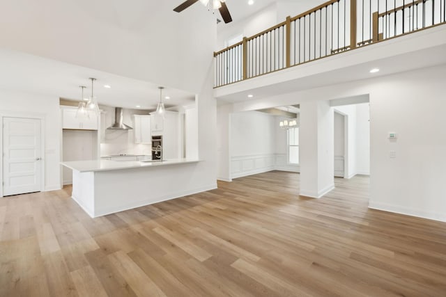 1065 Gholson Rd, Clarksville, TN 37043 - unfurnished living room with recessed lighting, ceiling fan, light wood-type flooring, and a high ceiling
