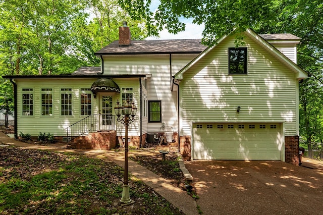 1505 Newmans Trl, Hendersonville, TN 37075 - traditional-style house featuring a chimney, an attached garage, and driveway