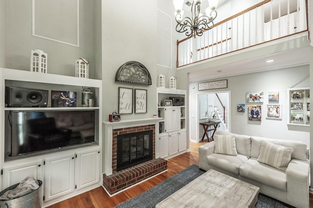 1505 Newmans Trl, Hendersonville, TN 37075 - living area with a high ceiling, a brick fireplace, wood finished floors, and a notable chandelier