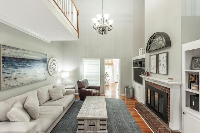 1505 Newmans Trl, Hendersonville, TN 37075 - living room with a brick fireplace, dark wood finished floors, a towering ceiling, and a notable chandelier