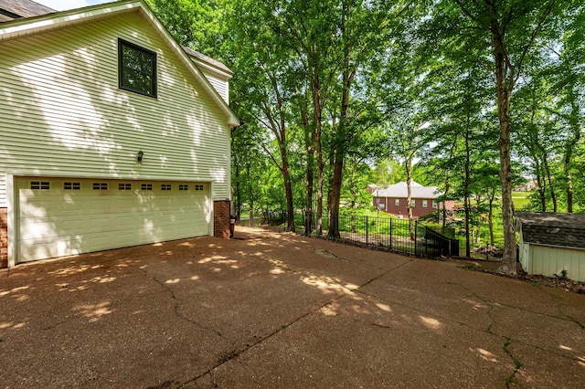 1505 Newmans Trl, Hendersonville, TN 37075 - view of side of property with brick siding, an attached garage, fence, and driveway