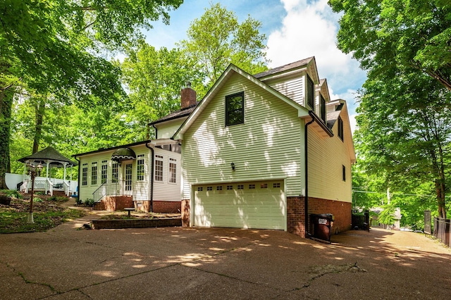 1505 Newmans Trl, Hendersonville, TN 37075 - view of home's exterior featuring a gazebo, a garage, a chimney, and concrete driveway