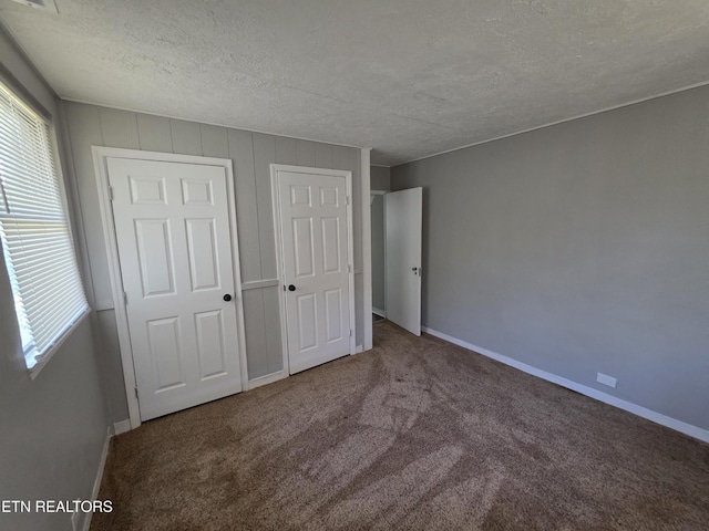 103 S Purdue Ave, Oak Ridge, TN 37830 - unfurnished bedroom featuring a textured ceiling, carpet floors, and a closet