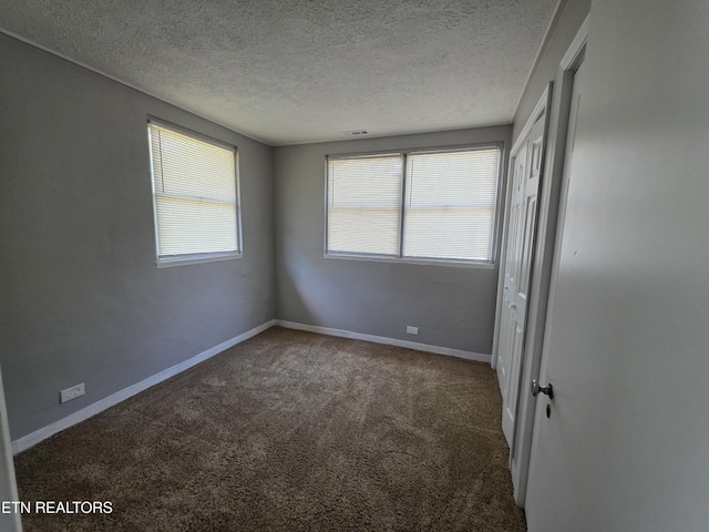 103 S Purdue Ave, Oak Ridge, TN 37830 - unfurnished bedroom featuring carpet floors, a textured ceiling, and a closet