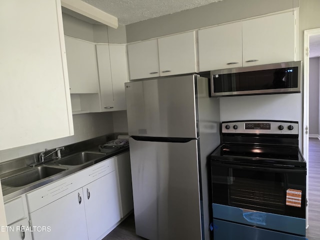 103 S Purdue Ave, Oak Ridge, TN 37830 - kitchen with stainless steel appliances, white cabinetry, a textured ceiling, and dark countertops