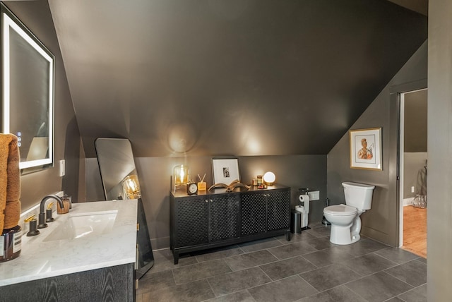 5959 River Trce, Nashville, TN 37218 - bathroom featuring toilet, vaulted ceiling, tile patterned flooring, and vanity