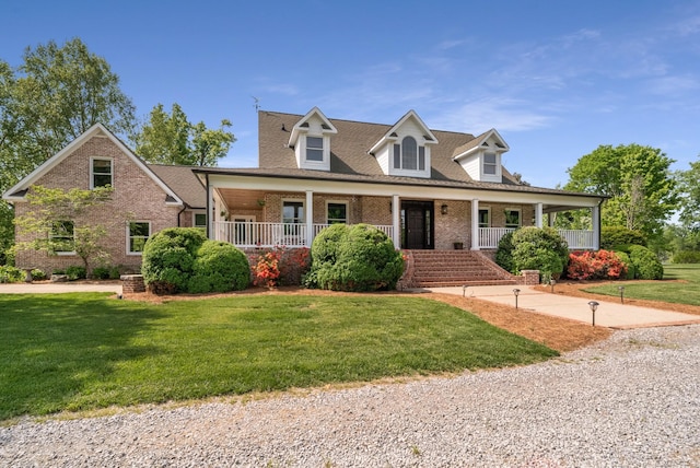 5959 River Trce, Nashville, TN 37218 - cape cod home featuring covered porch, brick siding, and a front lawn