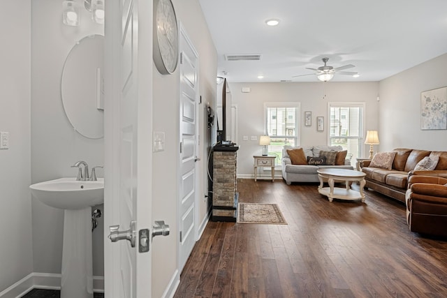interior space featuring a ceiling fan, visible vents, hardwood / wood-style flooring, baseboards, and recessed lighting
