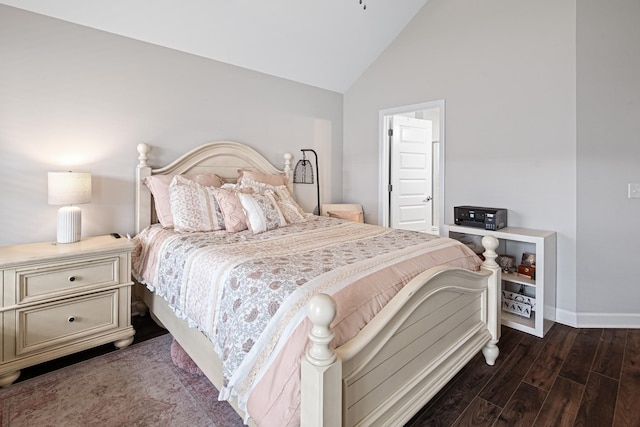 bedroom with baseboards, wood finished floors, and high vaulted ceiling