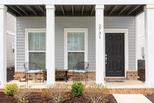 property entrance with covered porch and central AC
