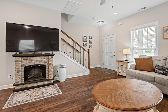 living area featuring ceiling fan, stairs, baseboards, wood finished floors, and visible vents