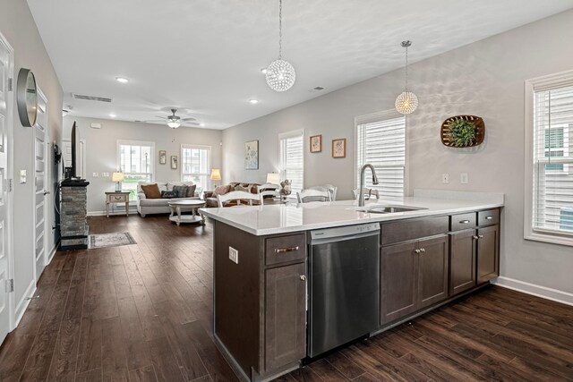 kitchen with stainless steel dishwasher, a sink, dark wood-style flooring, and dark brown cabinetry