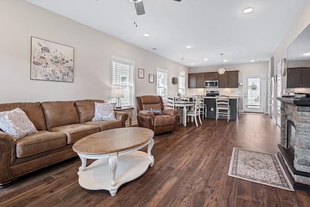 living area featuring recessed lighting, ceiling fan, dark wood-style floors, and a healthy amount of sunlight