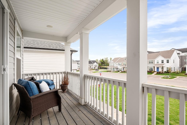 deck with a residential view and covered porch