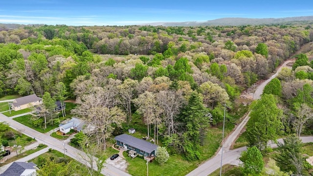 drone / aerial view featuring a forest view