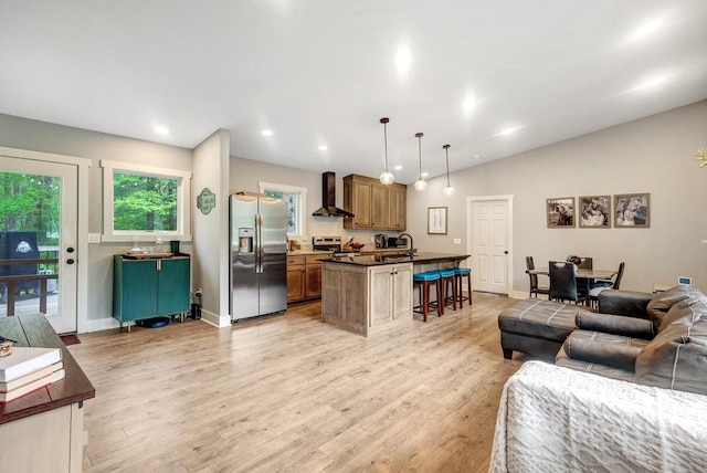 living room featuring recessed lighting, baseboards, light wood-type flooring, and lofted ceiling