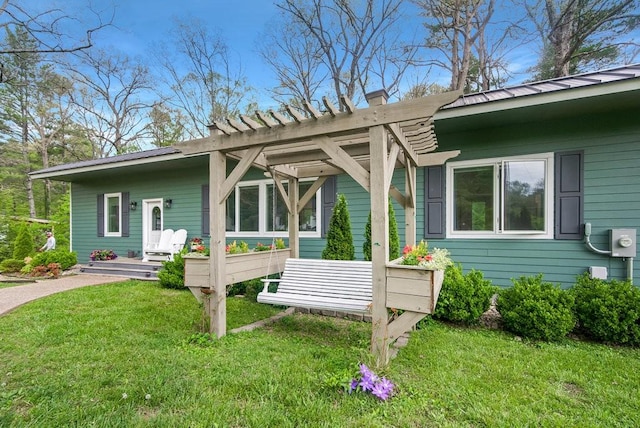 exterior space with a lawn, a chimney, and metal roof