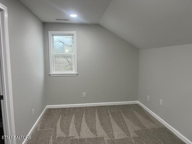 bonus room featuring lofted ceiling, carpet, baseboards, and visible vents
