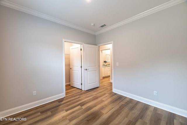 8888 Shaw Ferry Rd, Lenoir City, TN 37772 - unfurnished bedroom featuring baseboards, ornamental molding, wood finished floors, a walk in closet, and a closet