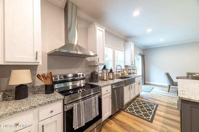 8888 Shaw Ferry Rd, Lenoir City, TN 37772 - kitchen featuring appliances with stainless steel finishes, wall chimney range hood, a sink, crown molding, and white cabinets