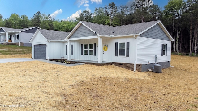 8888 Shaw Ferry Rd, Lenoir City, TN 37772 - view of front facade with crawl space, a porch, a garage, a shingled roof, and board and batten siding