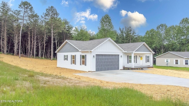 8888 Shaw Ferry Rd, Lenoir City, TN 37772 - view of front of house with a garage, concrete driveway, and board and batten siding