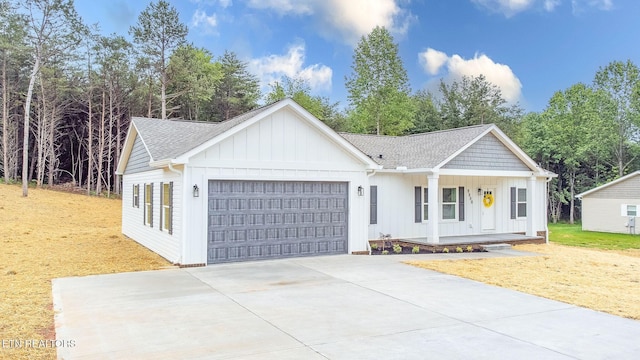 8888 Shaw Ferry Rd, Lenoir City, TN 37772 - modern farmhouse style home with a garage, a porch, concrete driveway, and board and batten siding