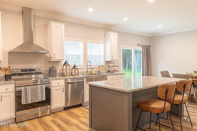 8888 Shaw Ferry Rd, Lenoir City, TN 37772 - kitchen featuring stainless steel appliances, wall chimney range hood, light wood-style floors, a breakfast bar area, and recessed lighting
