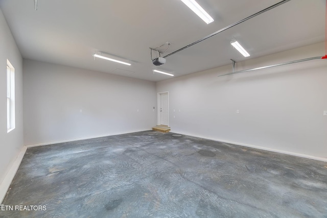 8888 Shaw Ferry Rd, Lenoir City, TN 37772 - garage featuring a garage door opener and baseboards