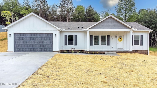 8888 Shaw Ferry Rd, Lenoir City, TN 37772 - view of front of house with an attached garage, covered porch, driveway, and roof with shingles