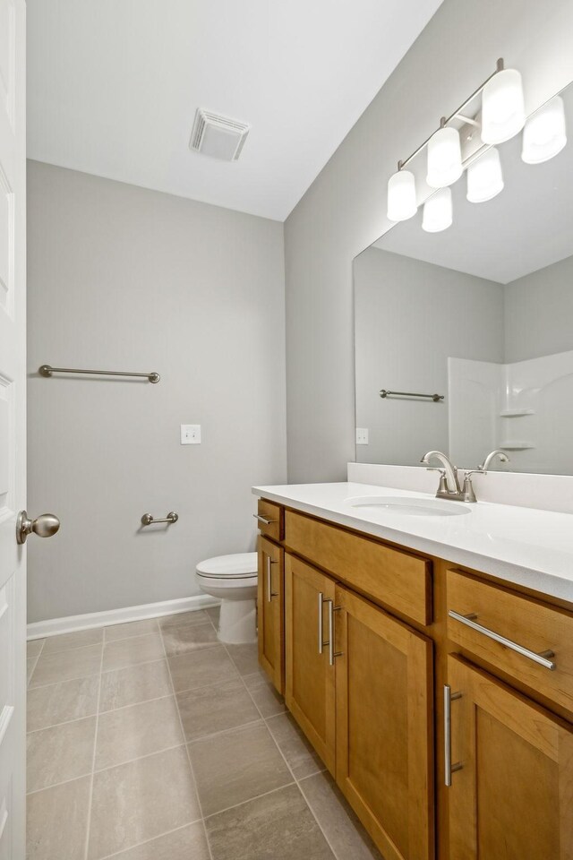 bathroom with toilet, tile patterned floors, visible vents, and vanity