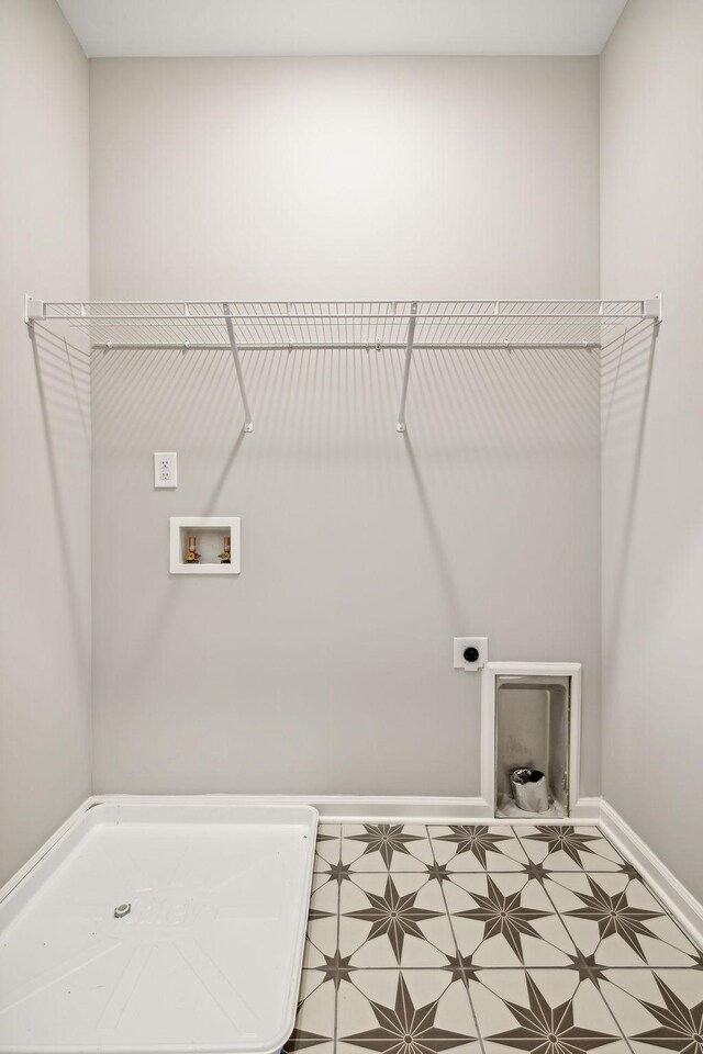 laundry room featuring hookup for an electric dryer, laundry area, tile patterned floors, baseboards, and hookup for a washing machine