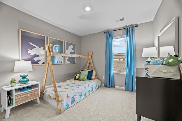 bedroom with baseboards, visible vents, and carpet