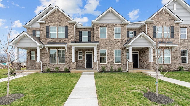 view of front of home featuring brick siding and a front lawn