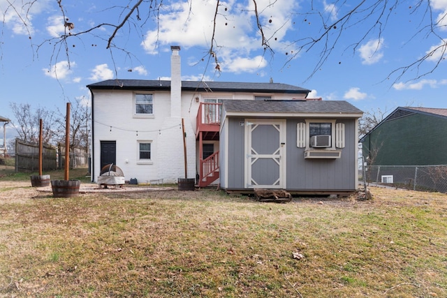 305 Aurora Ave, Madison, TN 37115 - rear view of property featuring an outdoor structure, fence, a chimney, a storage shed, and a yard
