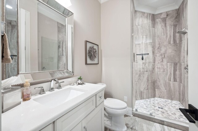 full bath with vanity, toilet, marble finish floor, a shower stall, and ornamental molding