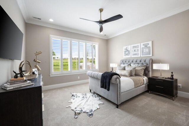 bedroom featuring light colored carpet, baseboards, visible vents, and ornamental molding