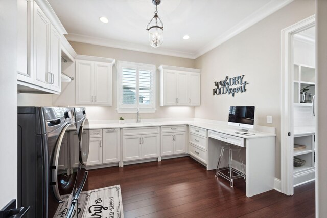 clothes washing area featuring washer and dryer, dark wood-style floors, a sink, and cabinet space