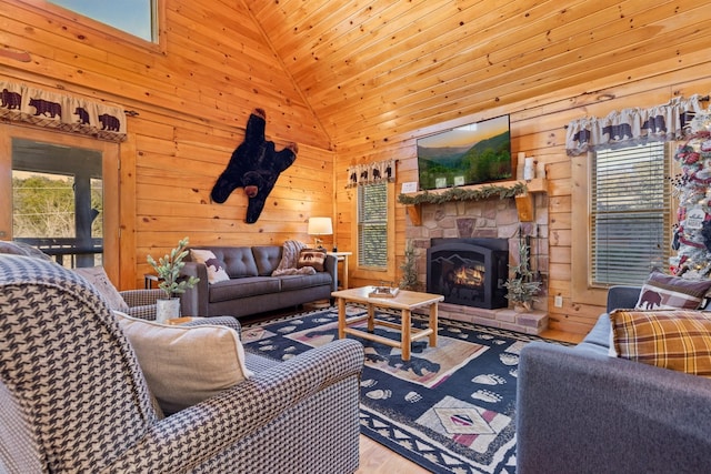 living room with wood walls, a fireplace, wood finished floors, and high vaulted ceiling