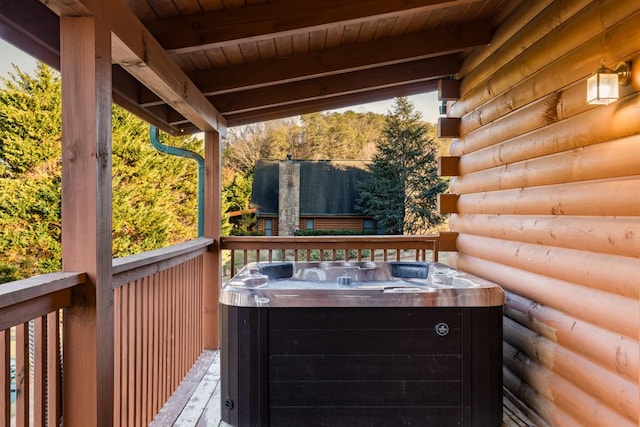 wooden deck featuring a hot tub