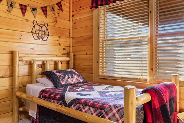 bedroom with wood walls