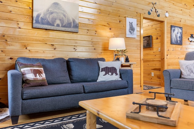 living area featuring wood walls and wood finished floors