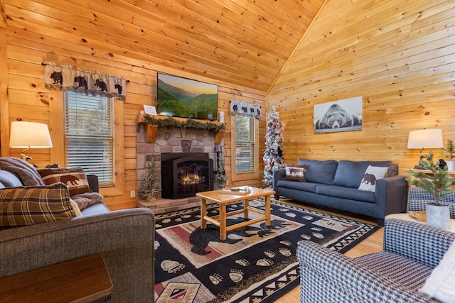 living area featuring wood walls, a stone fireplace, wood finished floors, lofted ceiling, and wood ceiling