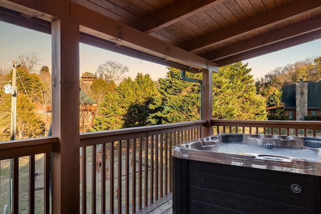 wooden deck featuring a hot tub