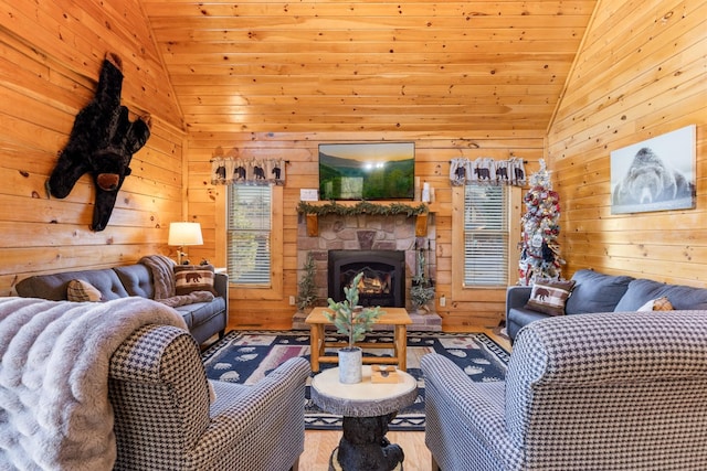 living area with wood walls, wood finished floors, a stone fireplace, wooden ceiling, and vaulted ceiling
