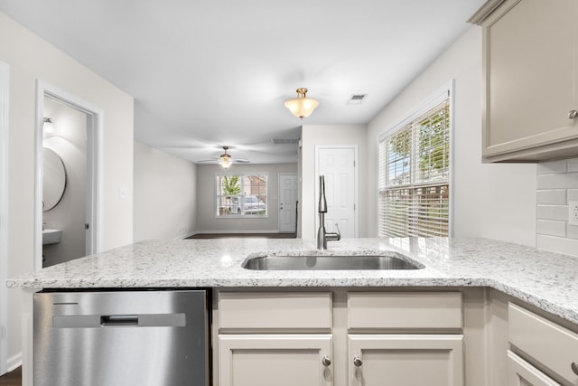 kitchen featuring visible vents, plenty of natural light, a sink, and dishwasher