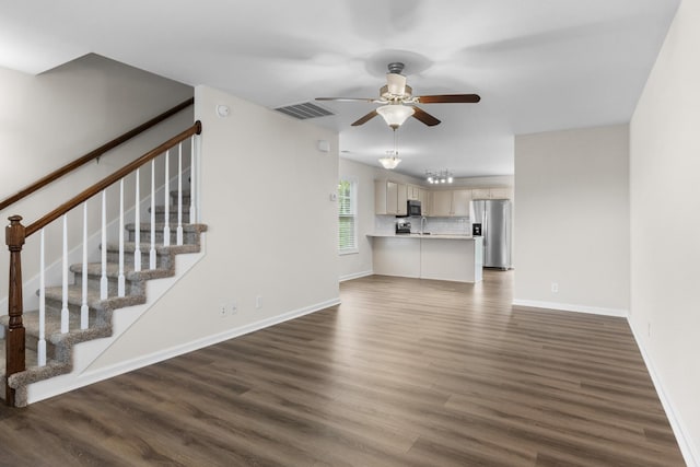 unfurnished living room with baseboards, a ceiling fan, dark wood-style flooring, and visible vents