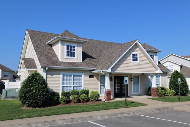 view of front of property with french doors, a shingled roof, and uncovered parking